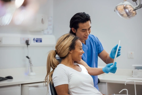 Dental assistant showing patient xray results